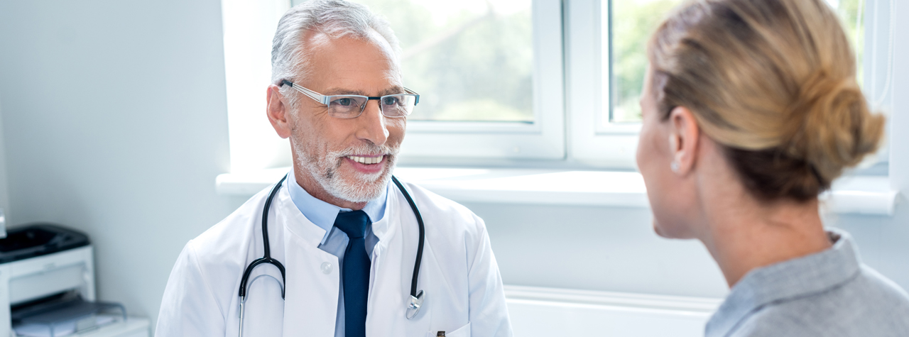 doctor in his office talking to a patient