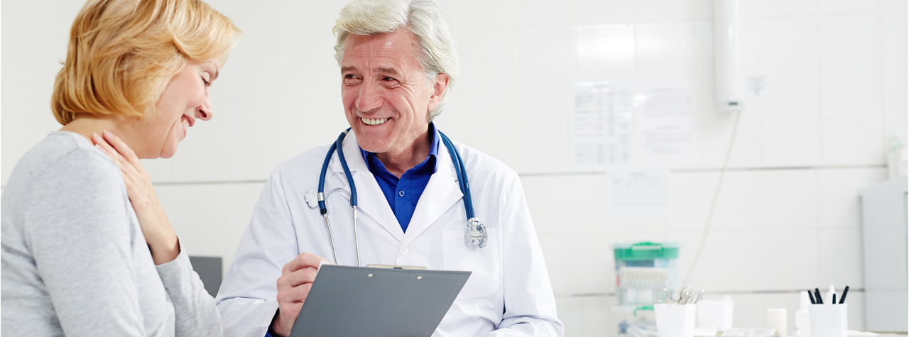 woman and doctor in doctors office talking