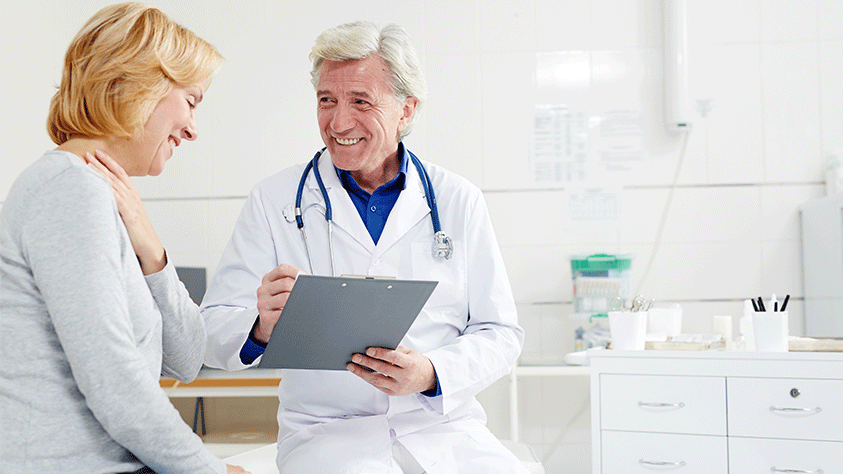 woman and doctor in doctors office talking